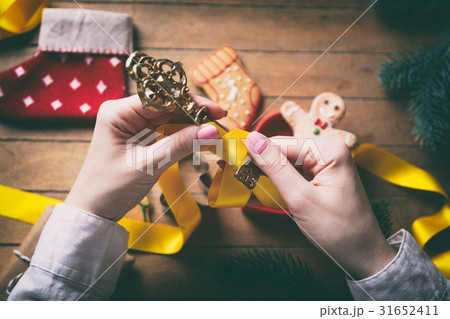 hands wrapping christmas gifts and cookies 31652411