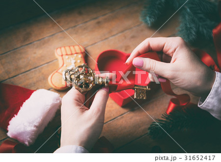 hands wrapping christmas golden key and gifts 31652417