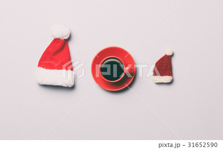 Red cup of coffee and two Santa Claus hats 31652590