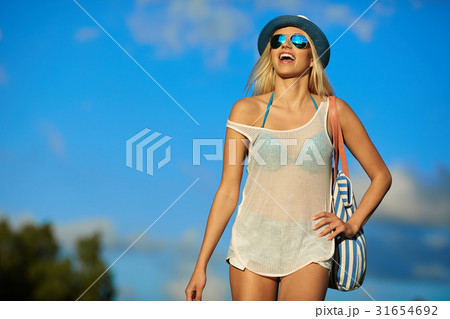 Beautiful joyful blond woman sunbathing at the seaside 31654692