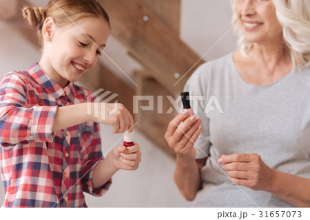 Happy pretty girl opening a nail varnish Happy pretty girl opening a nail varnish 31657073