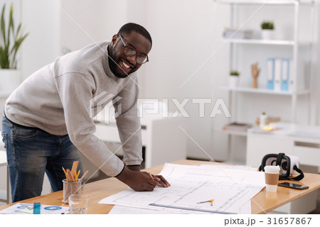 Cheerful positive engineer designing a building Cheerful positive engineer designing a building 31657867