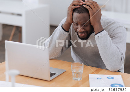 Cheerless moody man suffering from headache 31657982