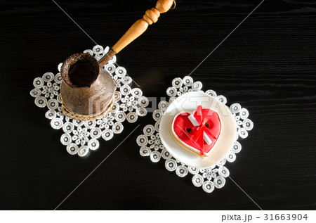 Jezva with coffee, saucer with red gingerbread 31663904