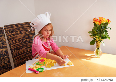 A girl preparing cookies 31664798