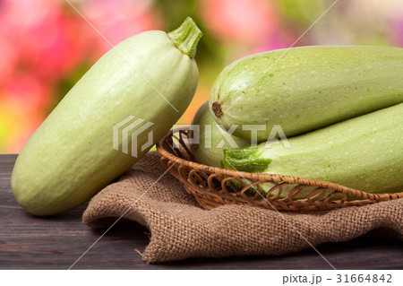courgettes on the wooden table with sacking and a courgettes on the wooden table with sacking and a 31664842
