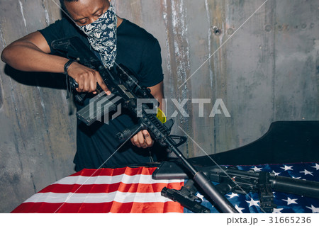 Black sniper aims at the rifle 31665236