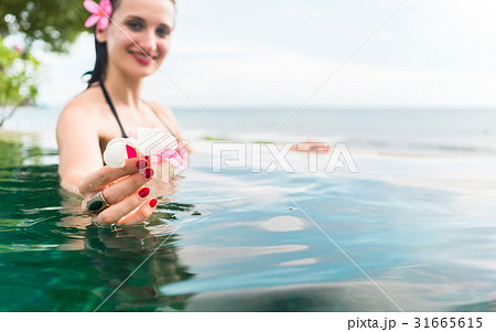 Woman in vacation relaxing swimming in pool  31665615