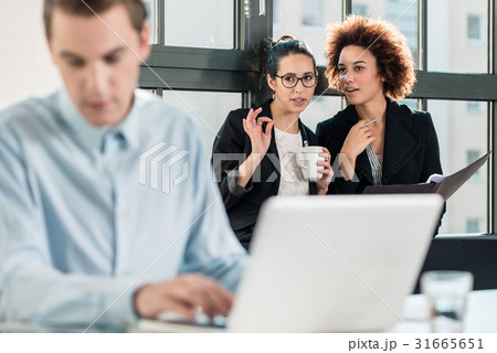 Two young women laughing behind their male Two young women laughing behind their male 31665651