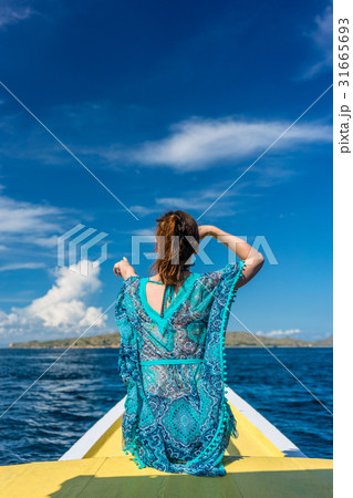 Young woman looking away to the horizon while Young woman looking away to the horizon while 31665693
