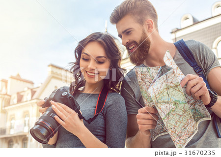 Young couple tourists city walk together vacation Young couple tourists city walk together vacation 31670235