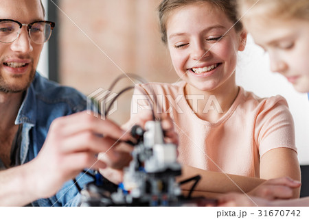 Hilarious smiling female teenager in workshop Hilarious smiling female teenager in workshop 31670742
