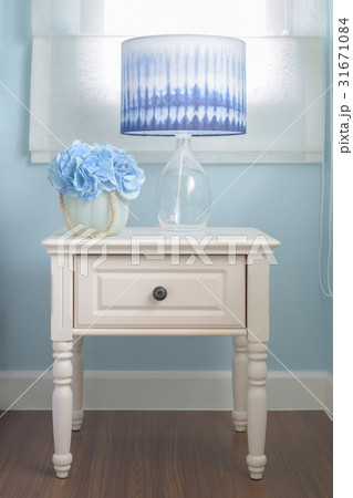 Flower jar and reading lamp on bedside table Flower jar and reading lamp on bedside table 31671084
