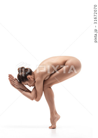 Serious naked woman situating in eagle pose Serious naked woman situating in eagle pose 31672070