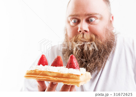 Starving fat man looking at dessert with shock Starving fat man looking at dessert with shock 31672625