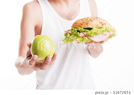 Slim young man making choice in eating 31672653