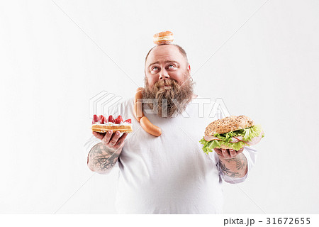 Cheerful thick guy carrying dessert and sandwich 31672655