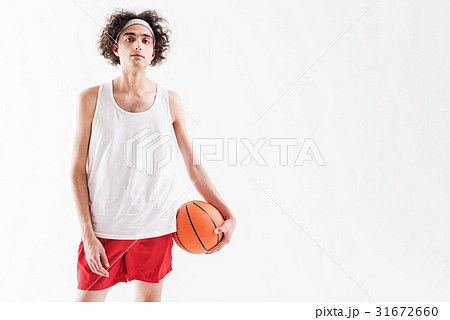Serious thin guy playing basketball Serious thin guy playing basketball 31672660