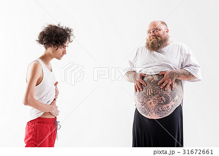 Male fatty boasting of his tummy to skinny guy Male fatty boasting of his tummy to skinny guy 31672661