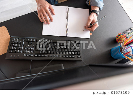 Manager making notes at notebook Manager making notes at notebook 31673109