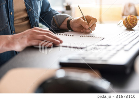 Man is writing necessary information 31673110