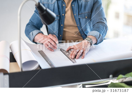 Man working on project in office Man working on project in office 31673187