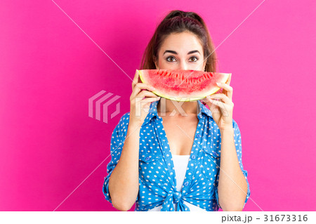 Happy young woman holding watermelon 31673316