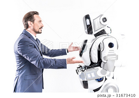 Cheerful male person talking to smart machine Cheerful male person talking to smart machine 31673410