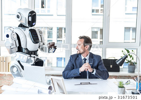 Robot-assistant is bringing beverage for smiling 31673501