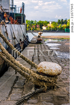 Boat docked to a mooring bollard at sunset 31677945