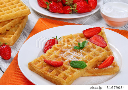 Belgian waffles with strawberries Belgian waffles with strawberries 31679084