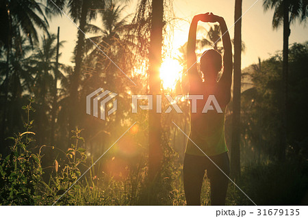 runner warming up before running at forest trail 31679135