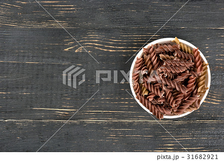 Dark fusilli pasta in bowl 31682921