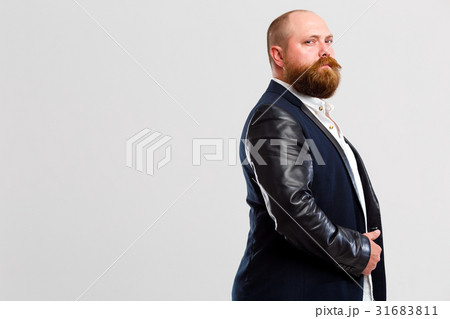 Man with beard stands sideways 31683811