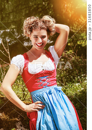 Cheerful young woman in dirndl Cheerful young woman in dirndl 31683850