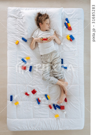 Peaceful nice boy dreaming about playing badminton 31685283