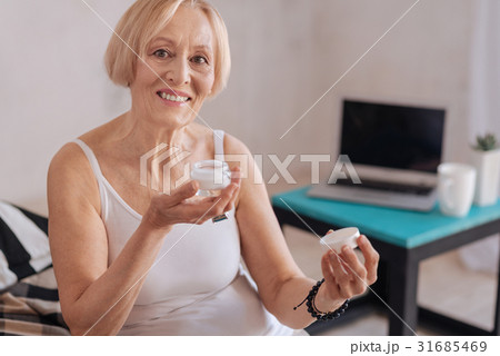 Experienced woman showing her new cream 31685469