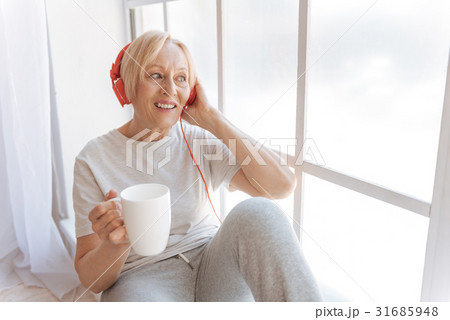Positive delighted lady putting left hand on the 31685948