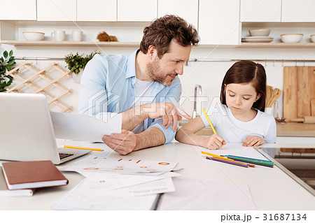 Father giving drawing tips to his daughter 31687134