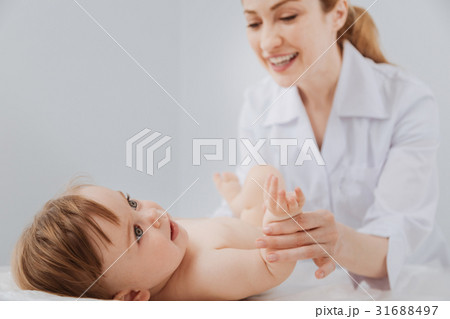 Cute distinguished pediatrician smiling during the Cute distinguished pediatrician smiling during the 31688497