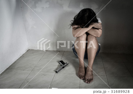 Sadness women with a handgun decided to suicide 31689928