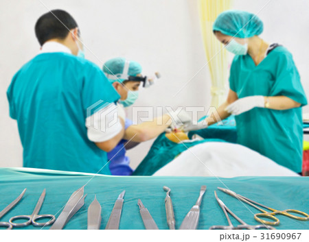 Team surgeon at work in the operating room. 31690967