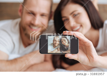 Young couple taking self portrait picture with Young couple taking self portrait picture with 31691957