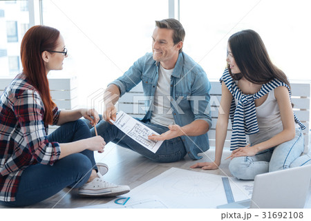 Handsome cheerful man holding a drawing Handsome cheerful man holding a drawing 31692108
