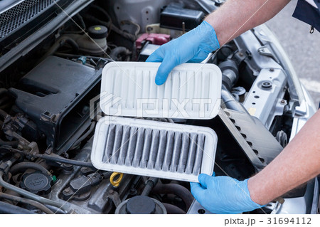 Car engine air filters, dirty and clean 31694112