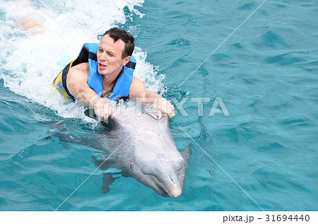 man holding dolphin fins 31694440