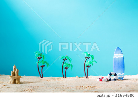 Summer theme with surfboard and sand castle 31694980