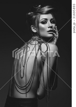 beautiful girl with many golden and bronze chains beautiful girl with many golden and bronze chains 31695893