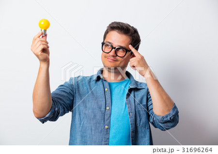 Young man in shirt holding bulb 31696264