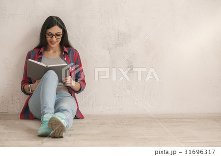 Young woman with a book studio portrait 31696317